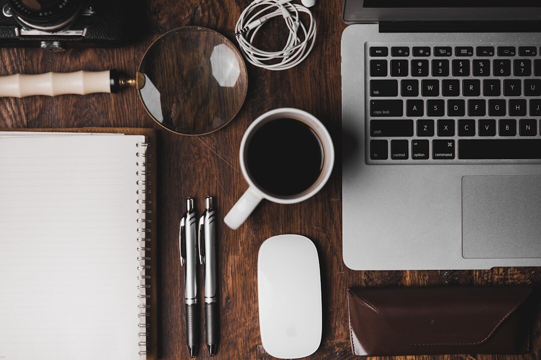 Overhead view of a desk with laptop notebook and coffee
